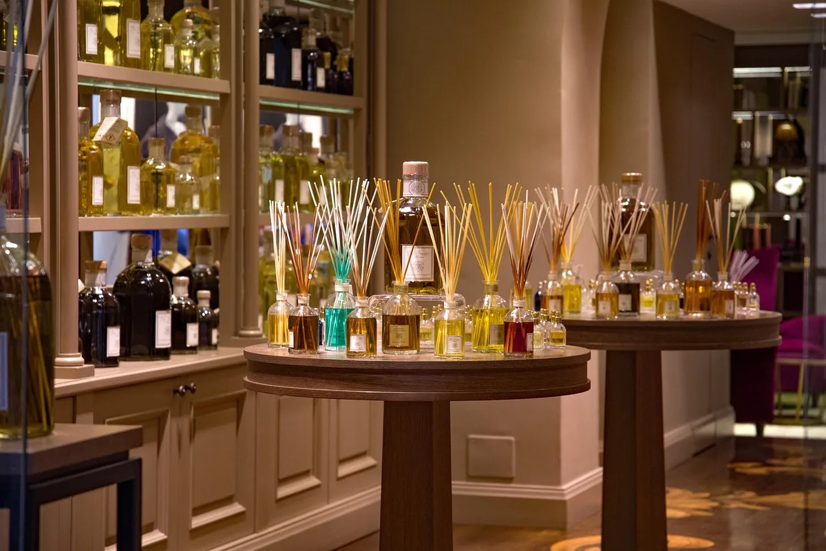 Boutique de perfumería con frascos en estantería de madera
